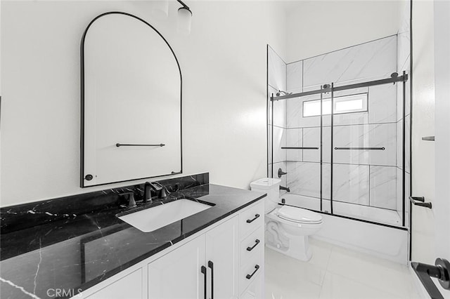 bathroom featuring toilet, shower / bath combination with glass door, and vanity