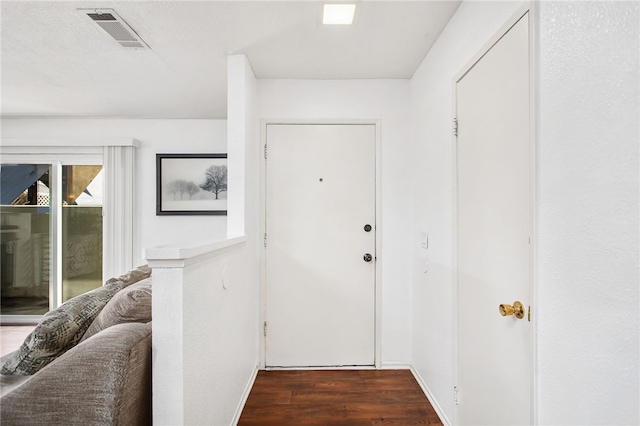 doorway to outside featuring visible vents and wood finished floors