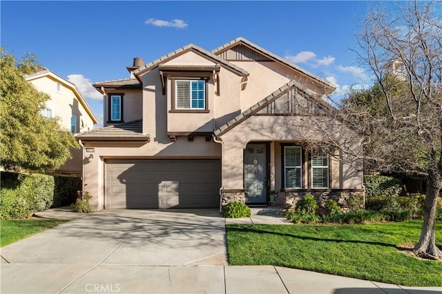 view of front of house with a garage, concrete driveway, stone siding, a tile roof, and stucco siding