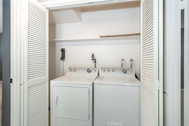 washroom featuring laundry area and separate washer and dryer