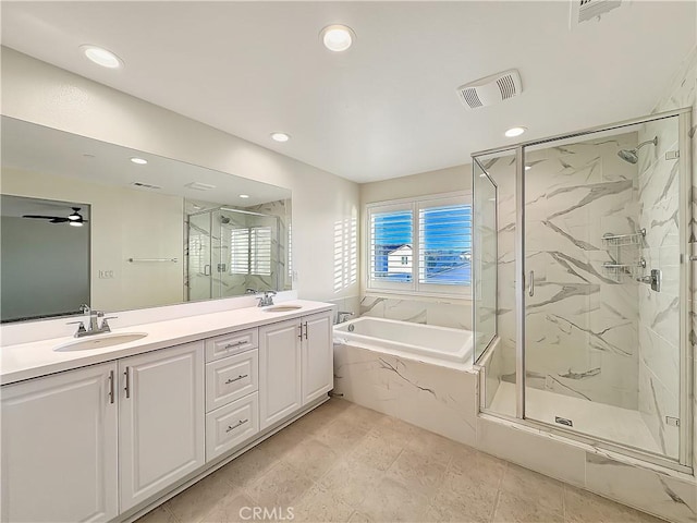 bathroom featuring double vanity, a marble finish shower, visible vents, a garden tub, and a sink