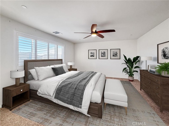 bedroom with ceiling fan, carpet floors, and visible vents