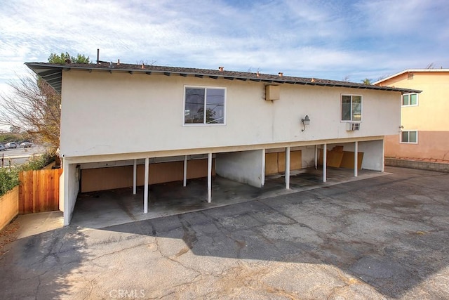 exterior space featuring covered parking and fence