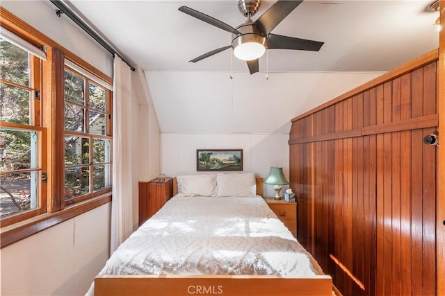 bedroom with lofted ceiling and a ceiling fan