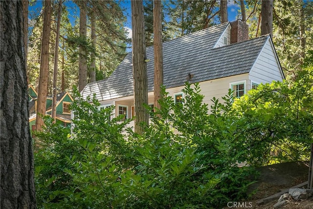 view of side of property with a chimney