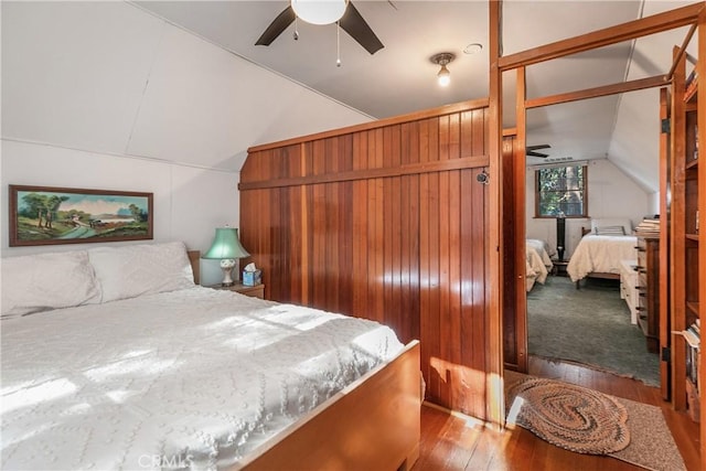 bedroom with lofted ceiling and light wood-style floors