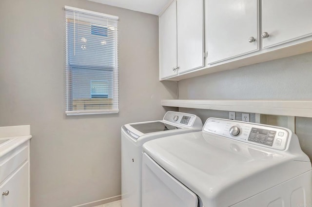 laundry area featuring independent washer and dryer and cabinet space