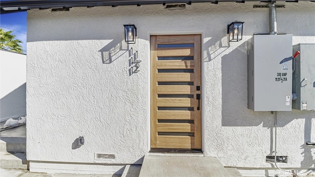 property entrance with stucco siding