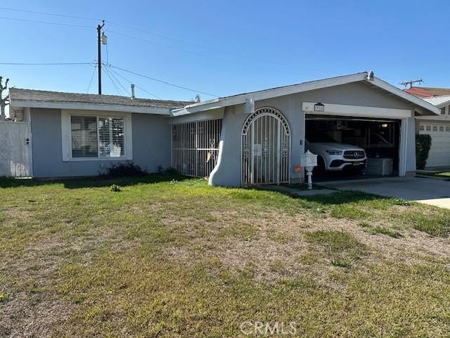 ranch-style home with an attached garage, driveway, a front lawn, and stucco siding