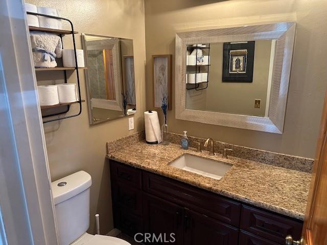 bathroom with toilet and vanity