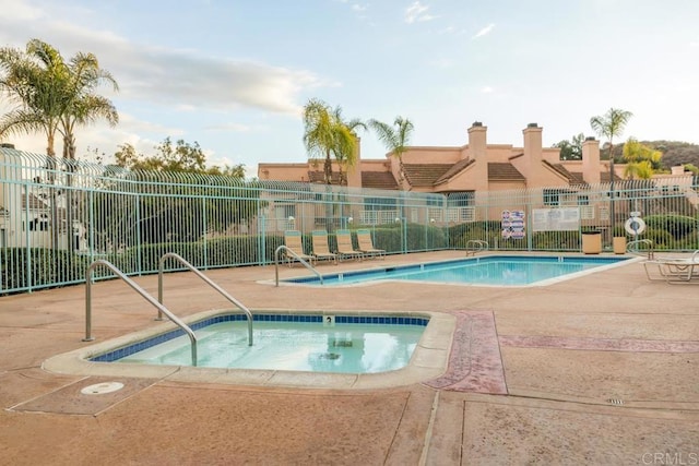 view of swimming pool with fence