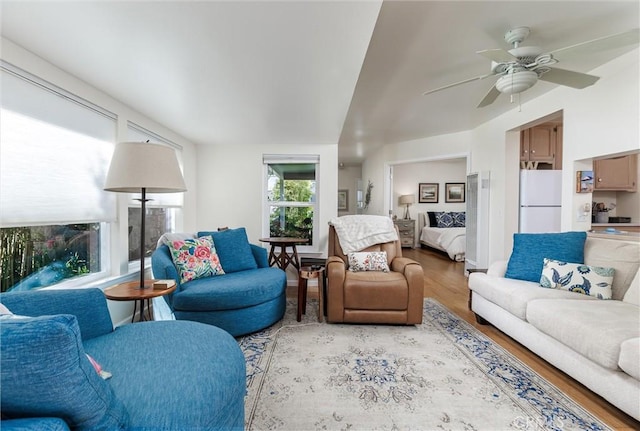 living room with a ceiling fan and wood finished floors