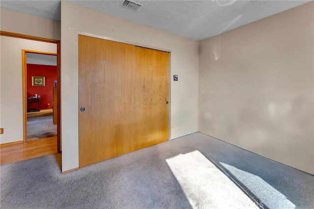 interior space with a textured ceiling and visible vents