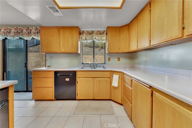 kitchen with dishwasher, light countertops, and a sink