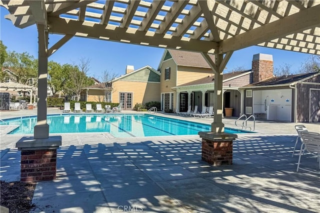 pool featuring a patio and a pergola