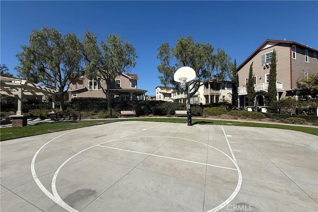 view of sport court with community basketball court, a residential view, and a pergola