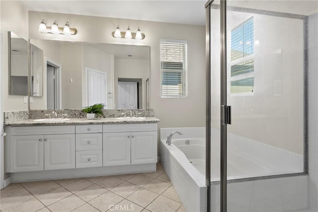 bathroom with a sink, a shower stall, a bath, and double vanity