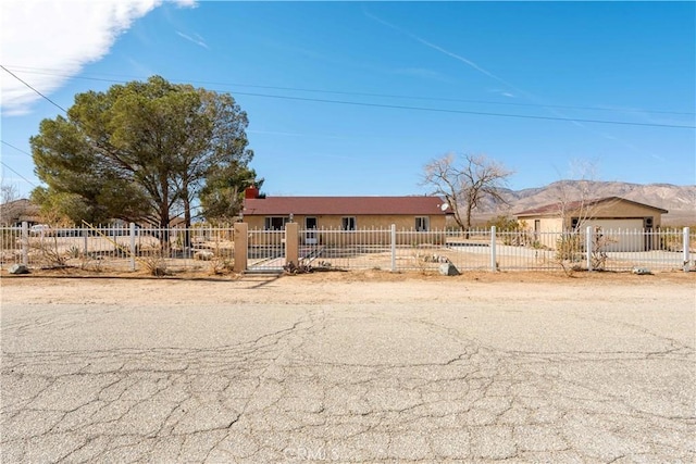 view of front of property with a fenced front yard and a mountain view