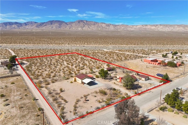 bird's eye view with a mountain view and view of desert