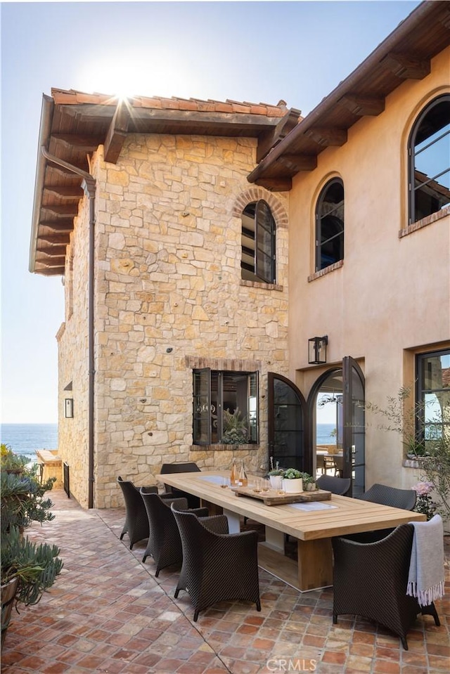 view of patio / terrace with outdoor dining area and a water view