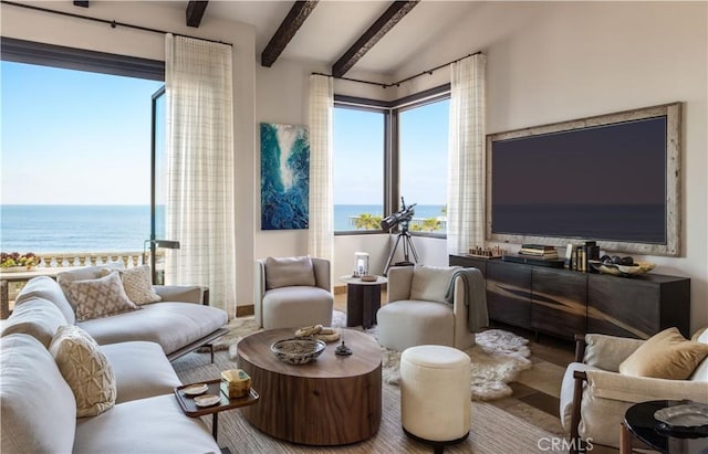 living room with a water view and beam ceiling