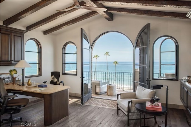 interior space featuring a water view, plenty of natural light, and wood finished floors