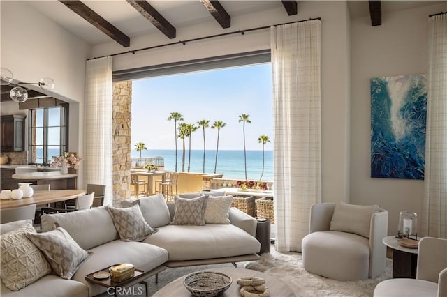 living room with beam ceiling and a water view