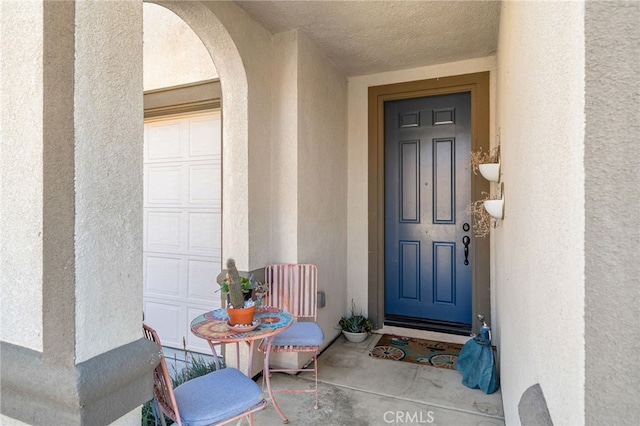 entrance to property with stucco siding