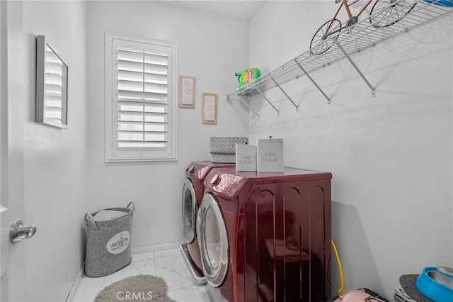 clothes washing area featuring laundry area, baseboards, marble finish floor, and independent washer and dryer