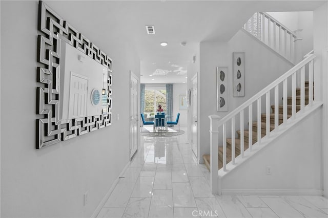 hallway with visible vents, baseboards, marble finish floor, stairs, and recessed lighting