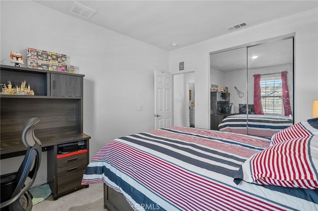 bedroom featuring a closet, visible vents, and light carpet