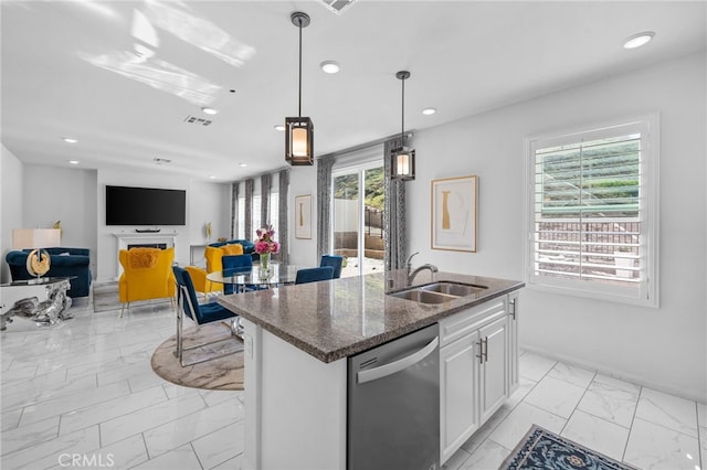 kitchen featuring a sink, white cabinets, marble finish floor, dishwasher, and a center island with sink