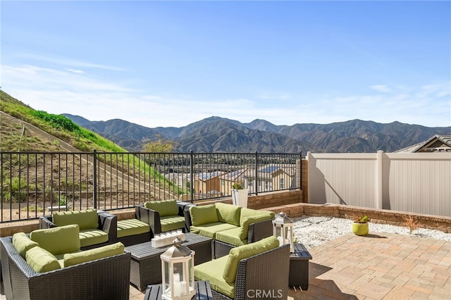 view of patio featuring a fenced backyard, a mountain view, and an outdoor hangout area