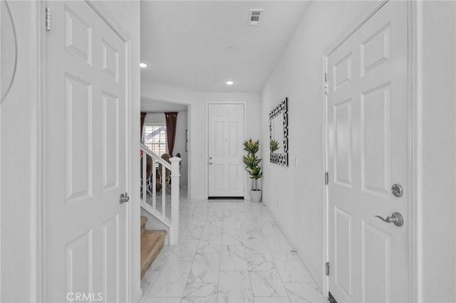 hallway featuring recessed lighting, marble finish floor, visible vents, and stairway