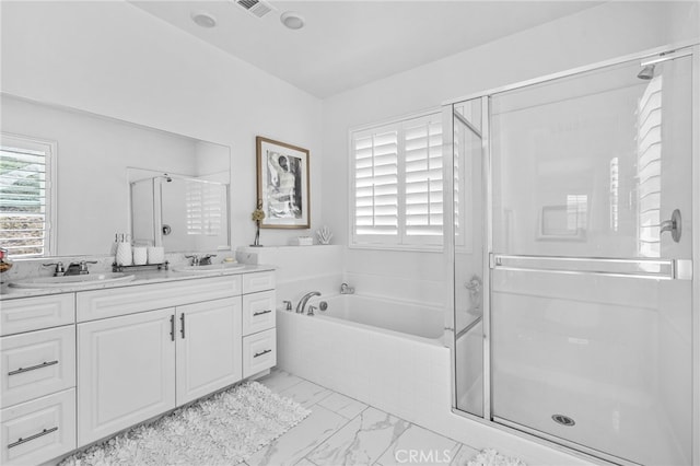 bathroom featuring a bath, marble finish floor, a shower stall, and a sink