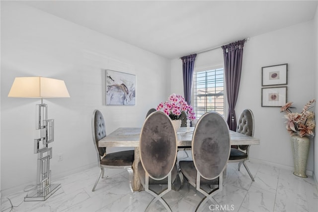 dining room featuring marble finish floor and baseboards