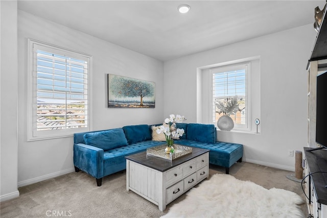 living room featuring light carpet and baseboards