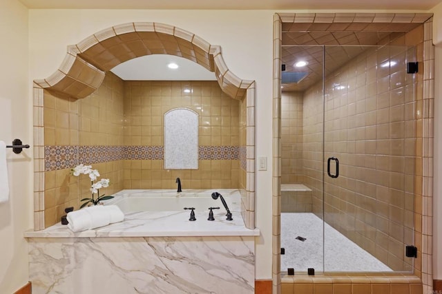 full bathroom featuring a stall shower and a garden tub