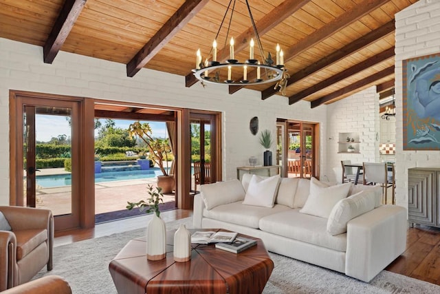 living room with a chandelier, wood ceiling, lofted ceiling with beams, and wood finished floors