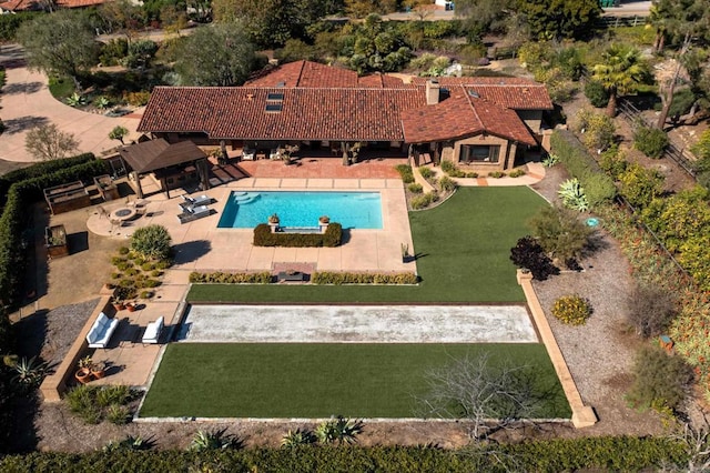 view of pool featuring a yard and a patio