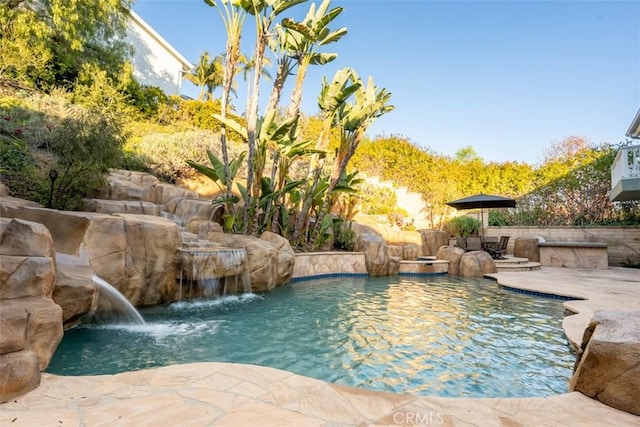 outdoor pool with a patio area