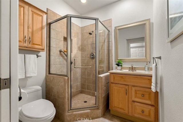 full bath with toilet, a stall shower, and vanity