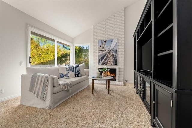 sitting room featuring light colored carpet, a brick fireplace, baseboards, and lofted ceiling