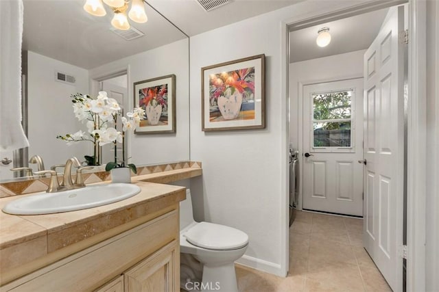 bathroom featuring visible vents, toilet, vanity, and tile patterned flooring