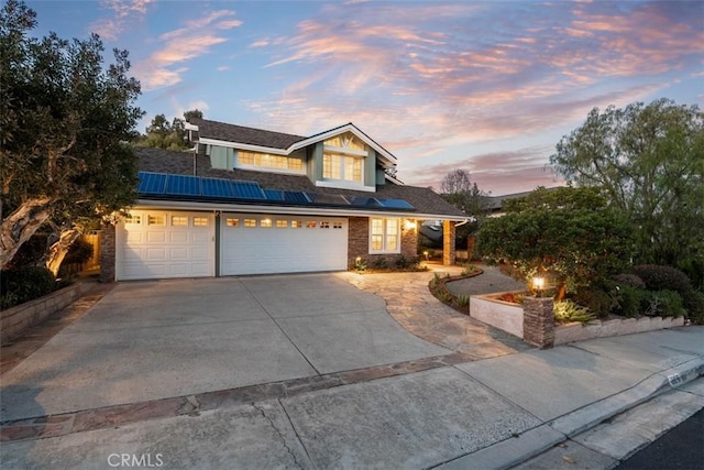 traditional-style home featuring concrete driveway and a garage