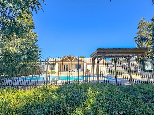 pool with fence and a pergola