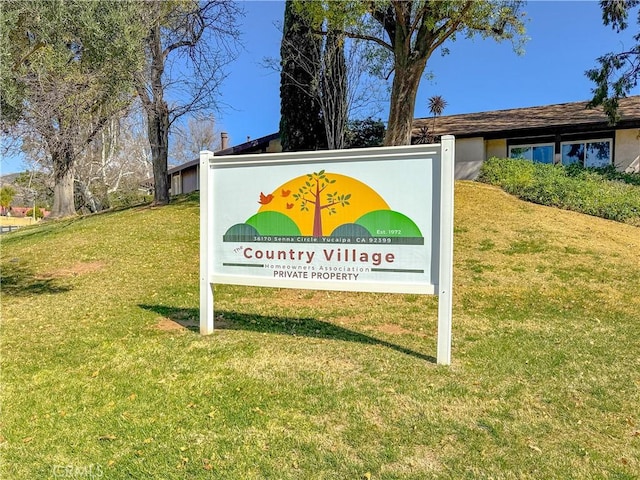 community / neighborhood sign with a lawn