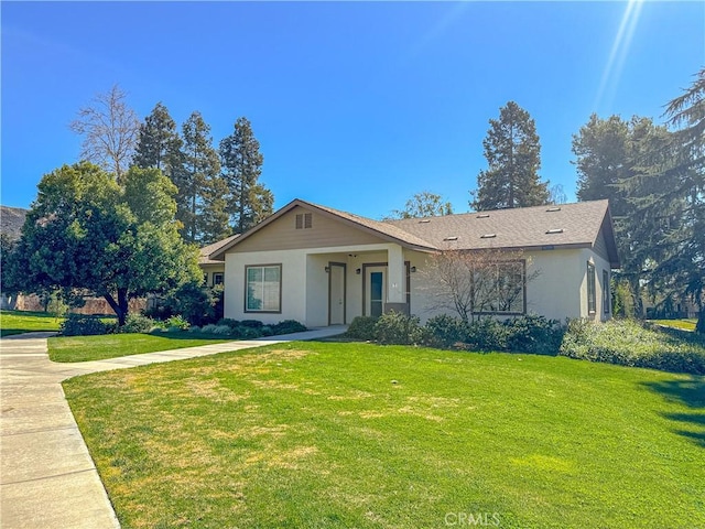 view of front of home with a front lawn and stucco siding