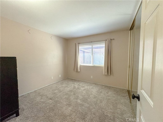 unfurnished bedroom featuring light carpet