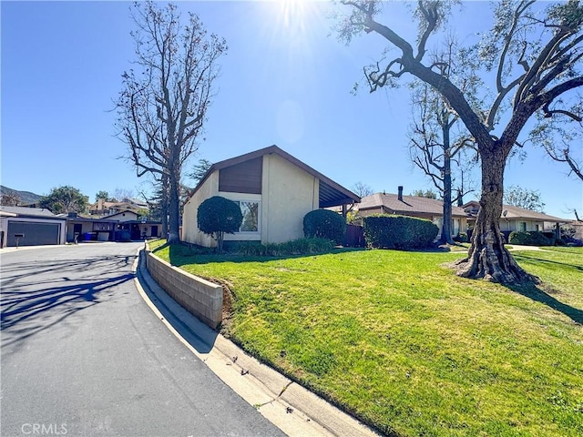 view of side of property featuring a yard and a residential view